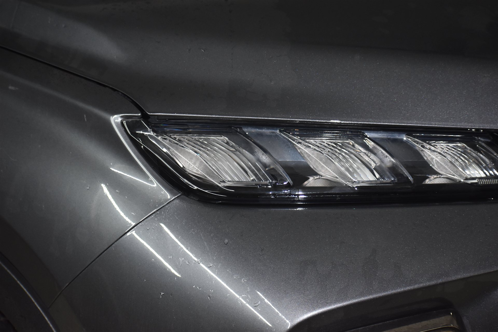 Mirror finish on metallic car headlight and front fender panel